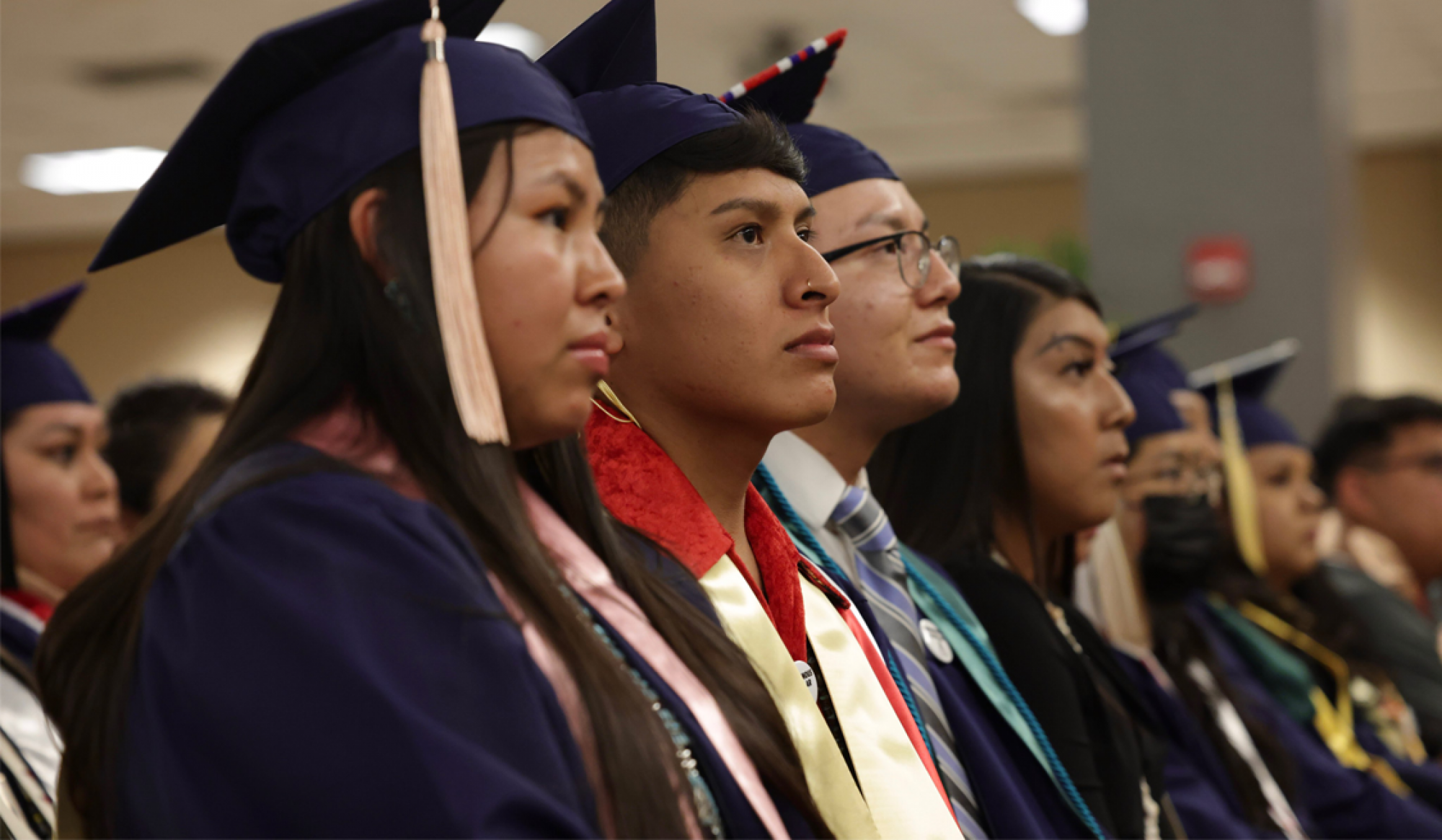 Students standing at a convocation ceremony.